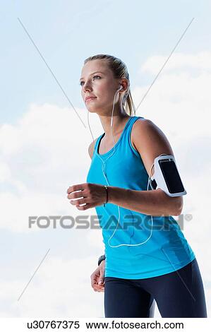 Portrait of young attractive woman running in park View Large Photo Image Stock Photography - Portrait of young attractive woman running in park. Fotosearch