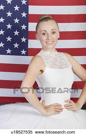 Stock Photography - Portrait of young ballet dancer standing against American flag. Fotosearch
