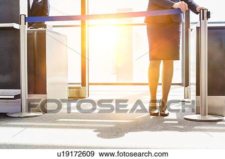 Portrait of young beautiful airport staff opening the gate for boarding in airport View Large Photo Image Stock Photo - Portrait of young beautiful airport staff opening the gate for boarding in airport . Fotosearch