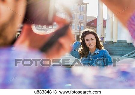 Portrait of young beautiful woman posing while being photograph by his boyfriend View Large Photo Image Stock Image - Portrait of young beautiful woman posing while being photograph by his boyfriend. Fotosearch