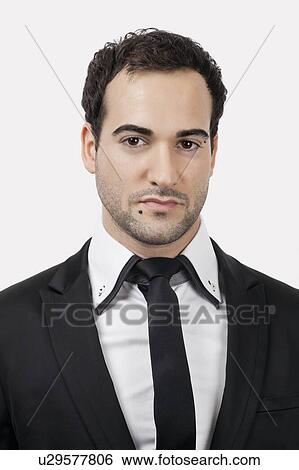 Stock Photograph - Portrait of young Caucasian businessman against white background. Fotosearch