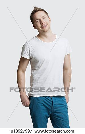 Stock Photo - Portrait of young Caucasian man in casuals smiling against white background. Fotosearch