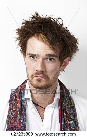 Portrait of young Caucasian man making a sad face against white background View Large Photo Image Stock Photo - Portrait of young Caucasian man making a sad face against white background. Fotosearch