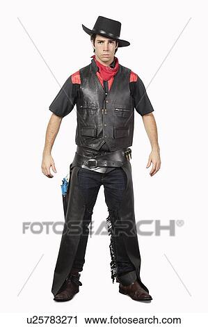 Portrait of young cowboy in black leather vest standing against gray background View Large Photo Image Stock Image - Portrait of young cowboy in black leather vest standing against gray background. Fotosearch
