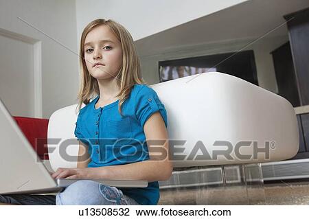 Portrait of young girl with laptop sitting in house View Large Photo Image Stock Image - Portrait of young girl with laptop sitting in house. Fotosearch