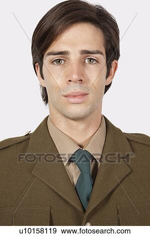 Portrait of young man in military uniform against gray background View Large Photo Image Stock Photo - Portrait of young man in military uniform against gray background. Fotosearch
