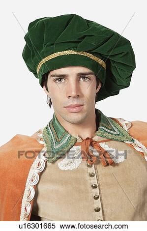 Stock Photography - Portrait of young man in old-fashioned costume against gray background. Fotosearch