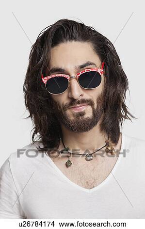 Portrait of young man in white t-shirt wearing sunglasses against white background View Large Photo Image Picture - Portrait of young man in white t-shirt wearing sunglasses against white background. Fotosearch