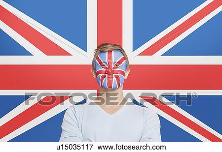 Portrait of young man in white t-shirt with face painting against British flag View Large Photo Image Stock Photo - Portrait of young man in white t-shirt with face painting against British flag. Fotosearch