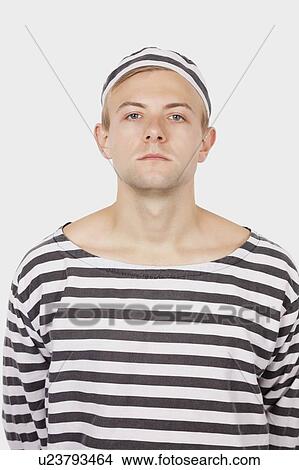 Portrait of young man wearing prisoner uniform against gray background View Large Photo Image Picture - Portrait of young man wearing prisoner uniform against gray background. Fotosearch