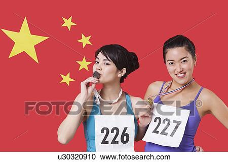 Portrait of young medalists standing against Chinese flag View Large Photo Image Stock Image - Portrait of young medalists standing against Chinese flag. Fotosearch