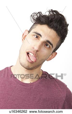 Stock Image - Portrait of young Middle Eastern man making funny faces over white background. Fotosearch