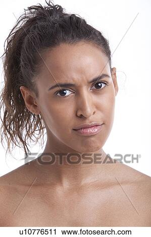 Stock Image - Portrait of young Mixed Race woman pouting against white background. Fotosearch