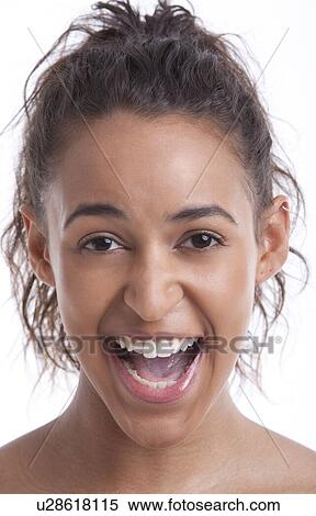 Portrait of young Mixed Race woman laughing against white background View Large Photo Image Stock Photography - Portrait of young Mixed Race woman laughing against white background. Fotosearch