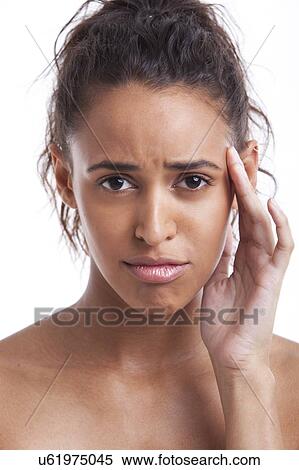 Portrait of young Mixed Race woman suffering from headache against white background View Large Photo Image Stock Photography - Portrait of young Mixed Race woman suffering from headache against white background. Fotosearch