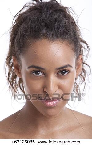 Stock Photography - Portrait of young Mixed Race woman smiling against white background. Fotosearch