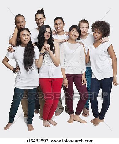 Portrait of young multi-ethnic friends posing together against white background View Large Photo Image Stock Image - Portrait of young multi-ethnic friends posing together against white background. Fotosearch
