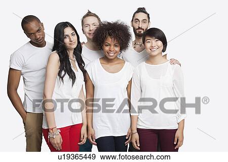 Stock Photo - Portrait of young multi-ethnic friends in casuals smiling together over white background. Fotosearch