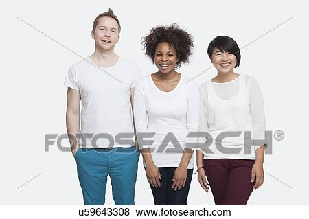 Stock Photo - Portrait of young multi-ethnic friends in casuals standing side by side over white background. Fotosearch