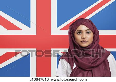 Portrait of young Muslim woman in traditional clothing standing against British flag View Large Photo Image Stock Image - Portrait of young Muslim woman in traditional clothing standing against British flag. Fotosearch
