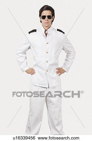 Portrait of young navy officer standing against gray background View Large Photo Image Stock Photograph - Portrait of young navy officer standing against gray background. Fotosearch