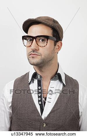 Portrait of young suspicious man against white background View Large Photo Image Stock Photography - Portrait of young suspicious man against white background. Fotosearch