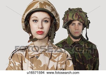 Portrait of young woman and man in military clothes against gray background View Large Photo Image Picture - Portrait of young woman and man in military clothes against gray background. Fotosearch