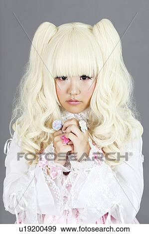 Portrait of young woman dressed as a doll over gray background View Large Photo Image Stock Photo - Portrait of young woman dressed as a doll over gray background. Fotosearch