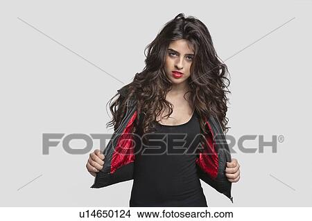 Portrait of young woman in stylish outfit over gray background View Large Photo Image Picture - Portrait of young woman in stylish outfit over gray background. Fotosearch