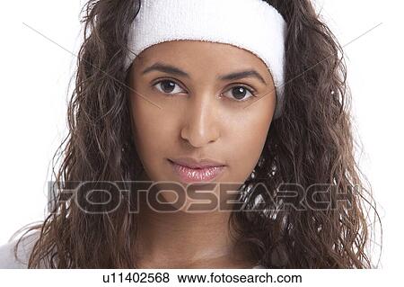Portrait of young woman with headband against white background View Large Photo Image Stock Photo - Portrait of young woman with headband against white background. Fotosearch