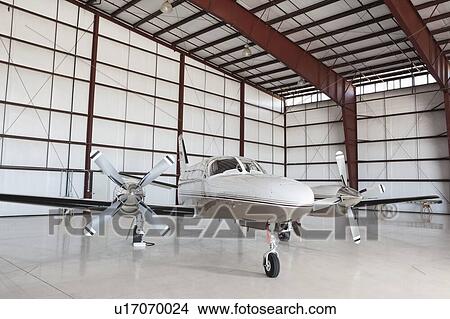 Private airplane parked in hangar View Large Photo Image Picture - Private airplane parked in hangar. Fotosearch