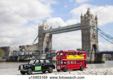 Stock Photo - Public transport figurines with London Bridge in the background. Fotosearch