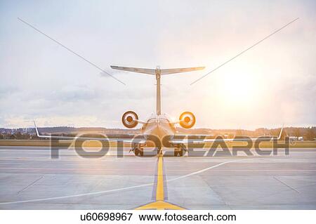 Rear view of airplane in airport View Large Photo Image Stock Photo - Rear view of airplane in airport. Fotosearch