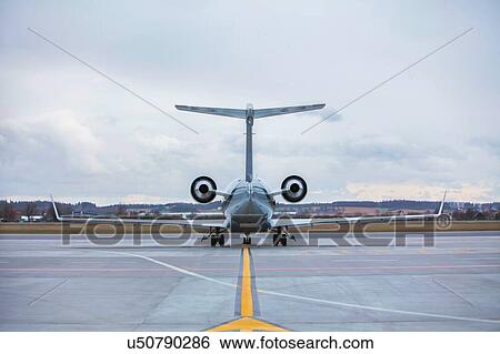 Stock Photograph - Rear view of airplane in airport. Fotosearch