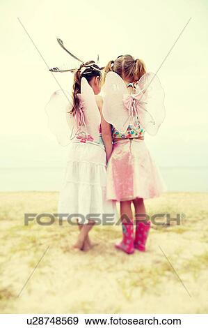 Rear view of two little girls dressed as angels View Large Photo Image Stock Photo - Rear view of two little girls dressed as angels. Fotosearch