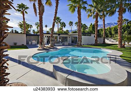 Stock Image - Residential pool with palm trees. Fotosearch