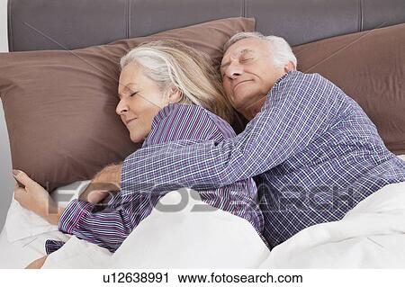 Romantic senior couple sleeping on bed at home View Large Photo Image Stock Image - Romantic senior couple sleeping on bed at home. Fotosearch