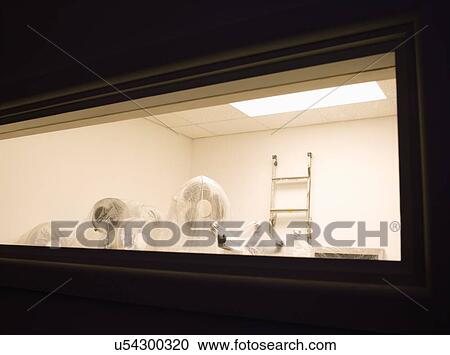 Stock Image - Room filled with things covered in plastic. Fotosearch