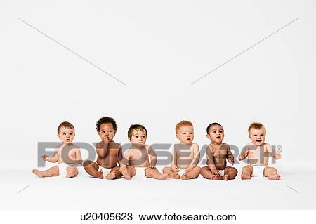 Stock Image - Row of six multi ethnic Babies smiling in studio. Fotosearch