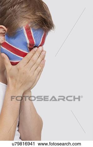 Sad young Caucasian man with British flag painted on face against white background View Large Photo Image Stock Image - Sad young Caucasian man with British flag painted on face against white background. Fotosearch