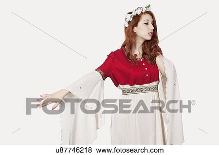 Stock Photo - Sad young woman in old-fashioned princess costume looking away against gray background. Fotosearch