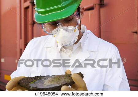 Picture - Safety inspector holding biological material. Fotosearch