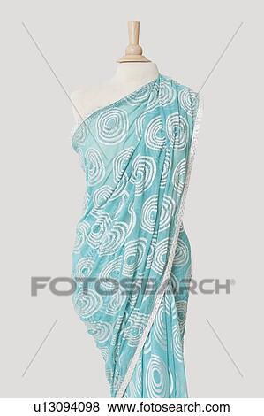Stock Photo - Sari draped on tailor's dummy against gray background. Fotosearch