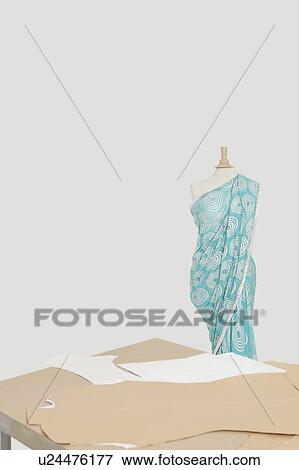 Sari draped on tailor's dummy with cardboard cuttings on table View Large Photo Image Stock Photo - Sari draped on tailor's dummy with cardboard cuttings on table. Fotosearch