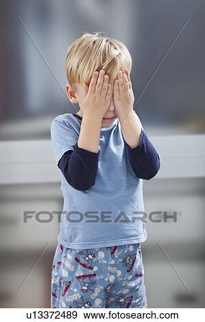 Scared little boy in casuals with hands over his eyes View Large Photo Image Stock Photo - Scared little boy in casuals with hands over his eyes. Fotosearch