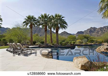 Stock Image - Scenic view mountains with swimming pool in foreground. Fotosearch