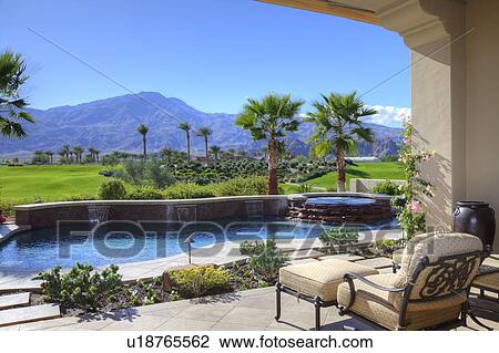 Stock Image - Scenic view of mountains and landscape from mansion patio. Fotosearch