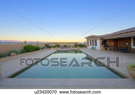 Stock Image - Scenic view of swimming pool with landscape in background. Fotosearch