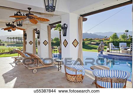 Seating furniture in patio of modern mansion View Large Photo Image Picture - Seating furniture in patio of modern mansion. Fotosearch