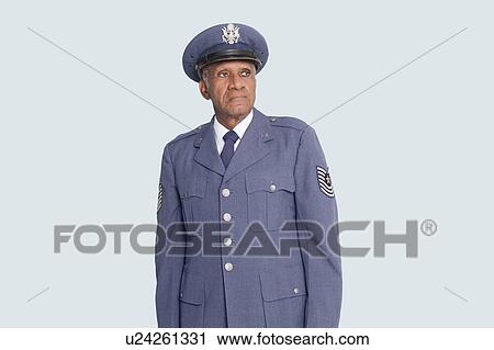 Senior male US Air Force officer standing over light blue background View Large Photo Image Stock Image - Senior male US Air Force officer standing over light blue background. Fotosearch